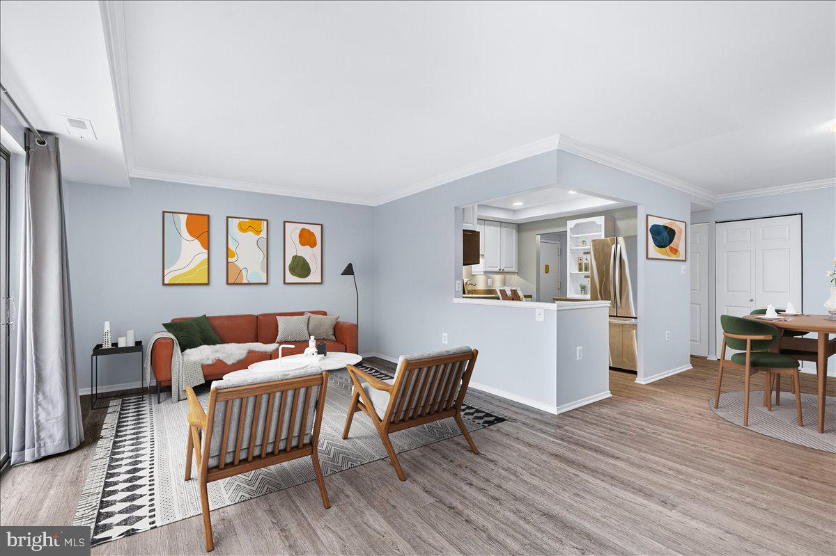 10000 Stedwick Road, Unit 104 Montgomery Village, MD 20886 - Photo 6 of 31 a bedroom with furniture and wooden floor
