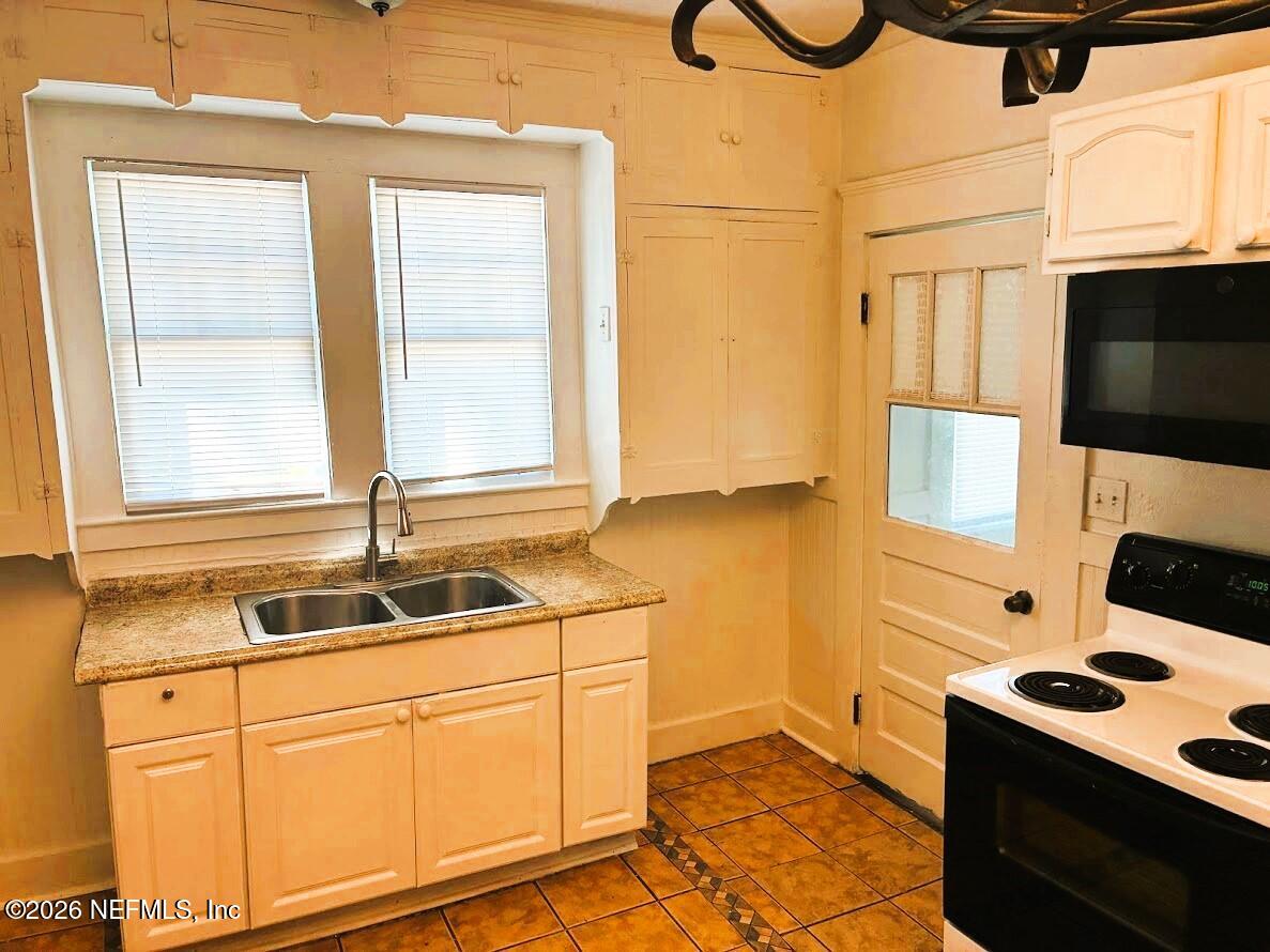 2036 Moncrief Road Jacksonville, FL 32209 - Photo 8 of 32 a kitchen with stainless steel appliances granite countertop a sink stove and cabinets