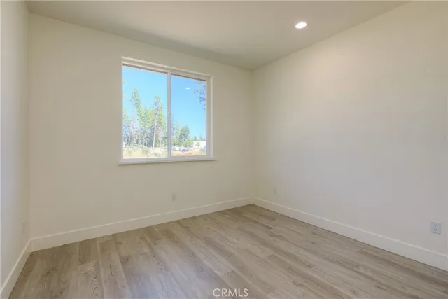 a kitchen with a sink cabinets and wooden floor
