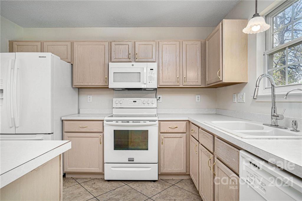 5532 Lemley Road Northwest Concord, NC 28027 - Photo 2 of 18 a kitchen with cabinets appliances a sink and a counter top space