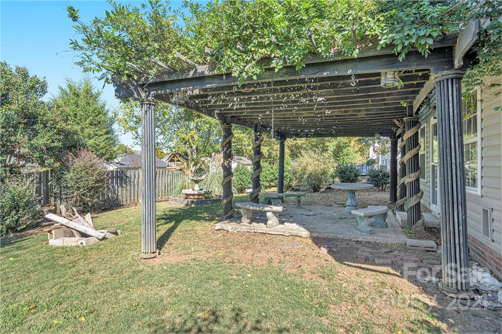 5532 Lemley Road Northwest Concord, NC 28027 - Photo 17 of 18 a backyard of a house with fountain table and chairs