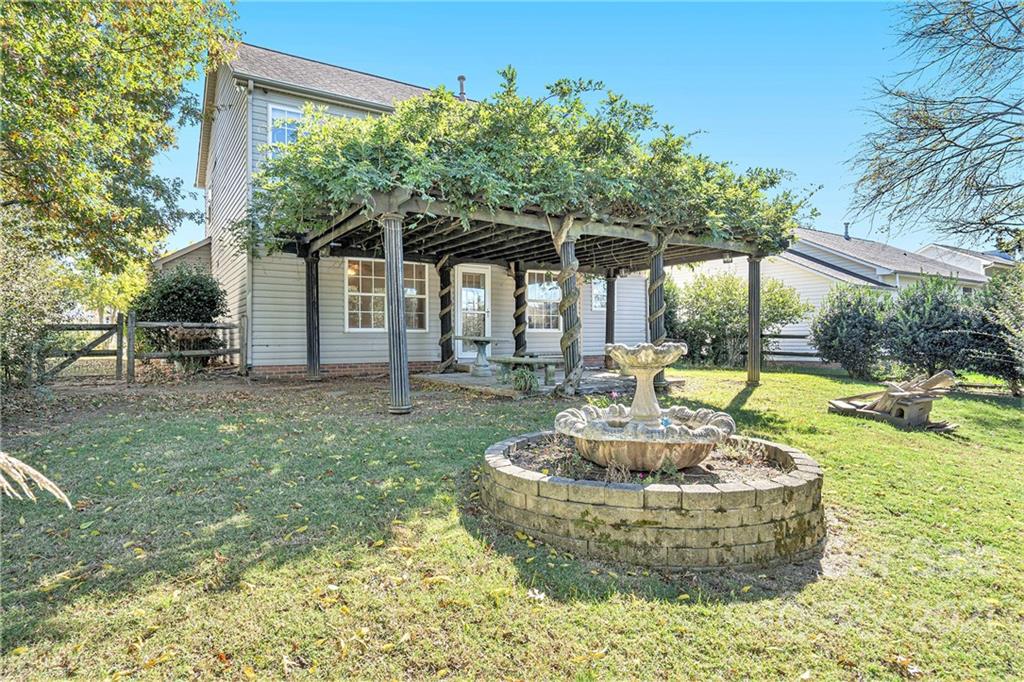 5532 Lemley Road Northwest Concord, NC 28027 - Photo 18 of 18 a view of a house with backyard and sitting area