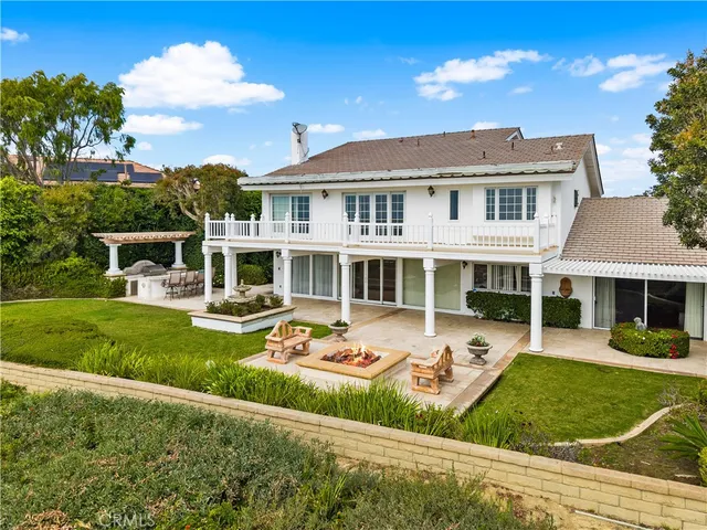 a view of a house with a big yard and large trees
