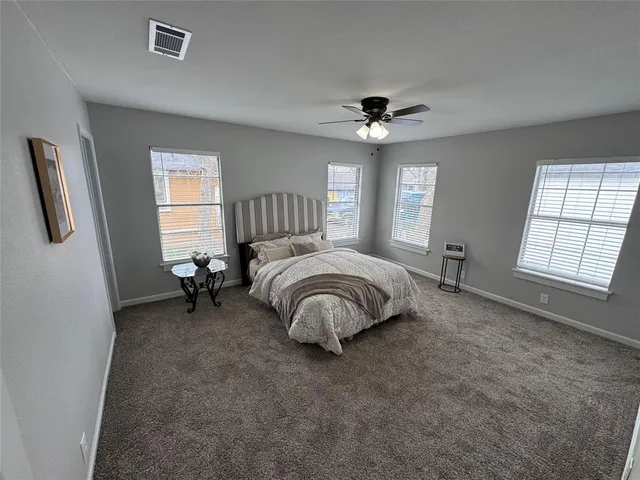 a bathroom with a sink a toilet a mirror and shower