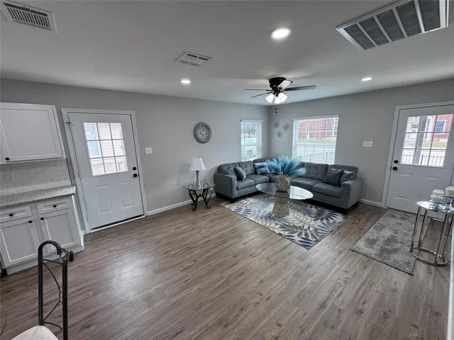 a living room with furniture window and wooden floor