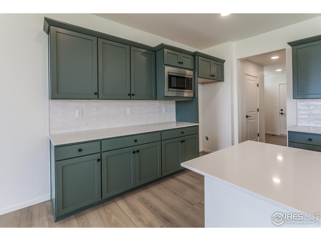 6126 Red Barn Road Fort Collins, CO 80528 - Photo 12 of 36 a kitchen with a sink and a refrigerator