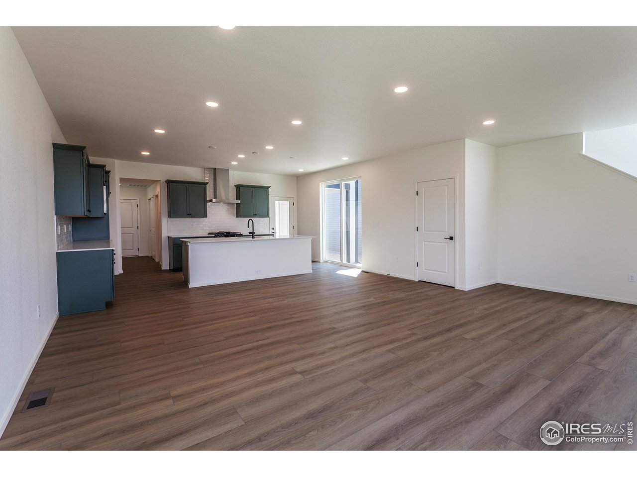 6126 Red Barn Road Fort Collins, CO 80528 - Photo 3 of 36 a view of kitchen with kitchen island granite countertop wooden floors and wide window