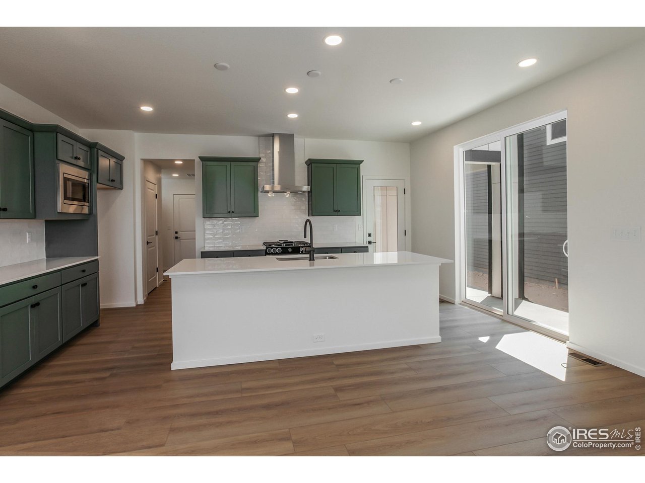 6126 Red Barn Road Fort Collins, CO 80528 - Photo 6 of 36 a view of kitchen with stainless steel appliances granite countertop a large counter top and wooden floors