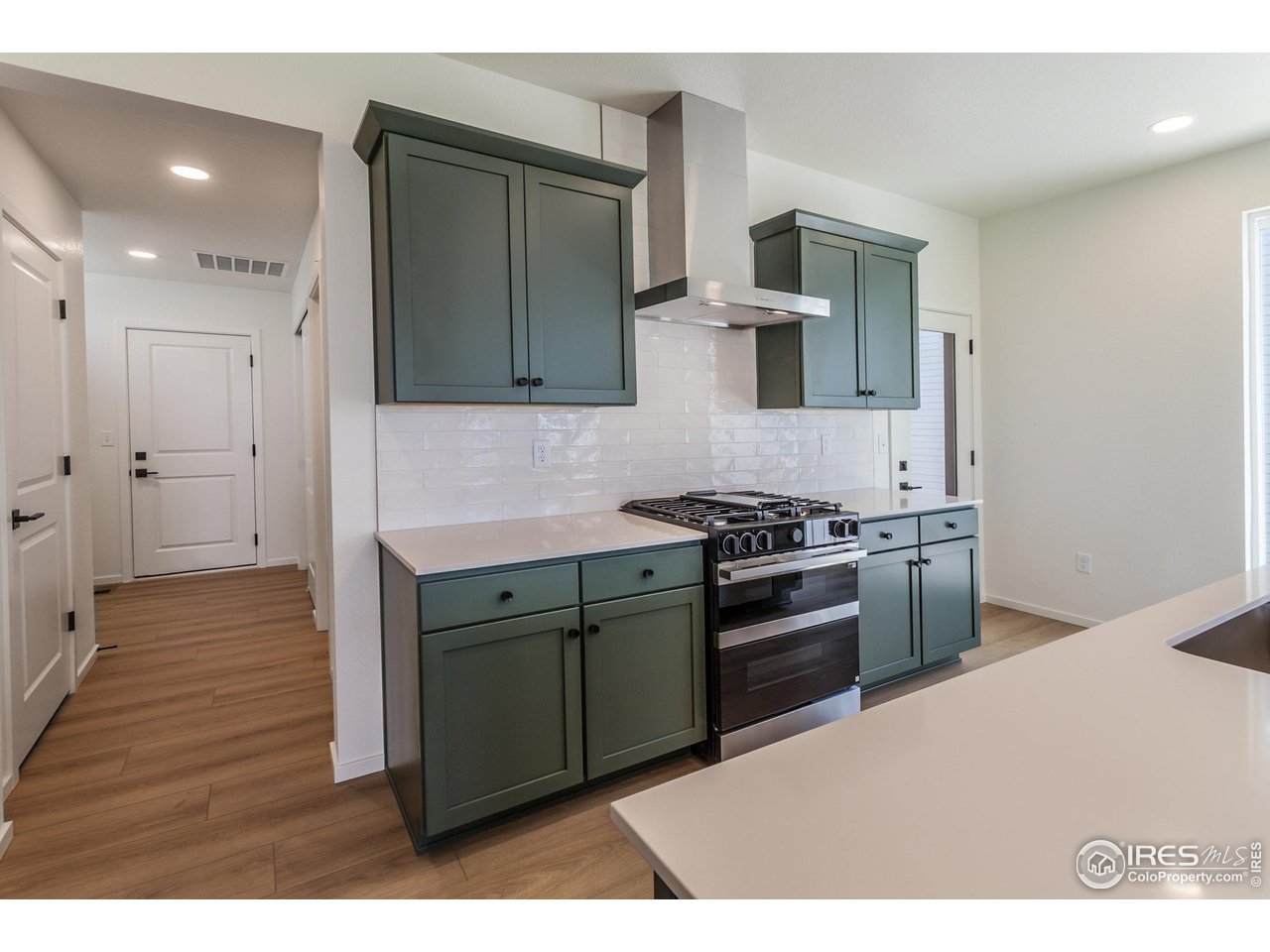6126 Red Barn Road Fort Collins, CO 80528 - Photo 9 of 36 a kitchen with a stove and a refrigerator
