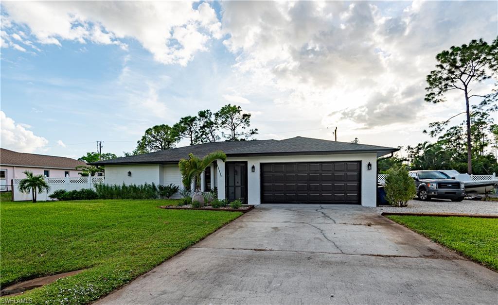 18386 Tulip Road Fort Myers, FL 33967 - Photo 1 of 25 a front view of a house with garden