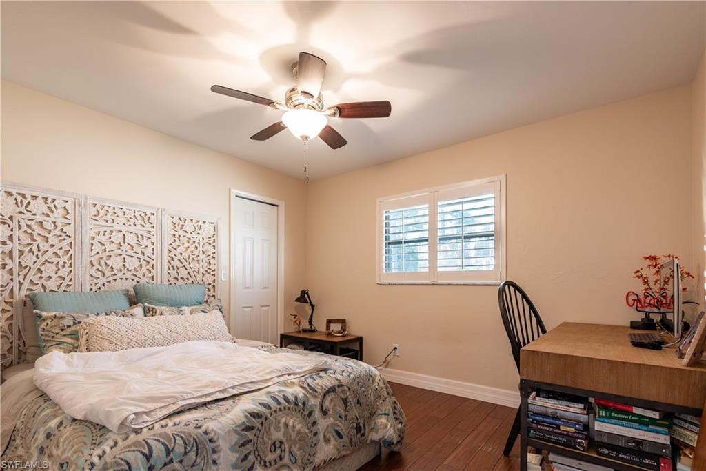 18386 Tulip Road Fort Myers, FL 33967 - Photo 14 of 25 a bedroom with a large bed and a desk