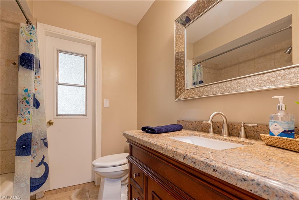 18386 Tulip Road Fort Myers, FL 33967 - Photo 15 of 25 a bathroom with a granite countertop sink and a toilet