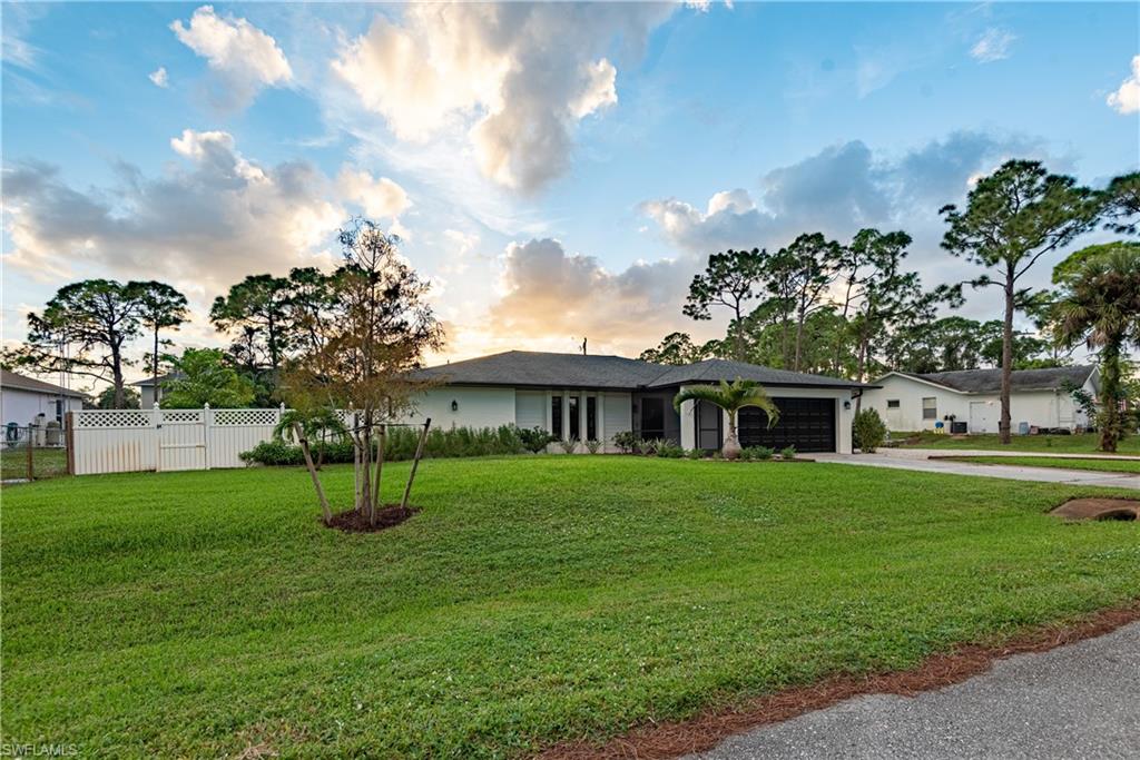 18386 Tulip Road Fort Myers, FL 33967 - Photo 3 of 25 a front view of a house with a garden