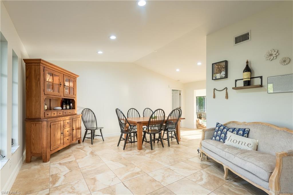 18386 Tulip Road Fort Myers, FL 33967 - Photo 5 of 25 a living room with furniture a flat screen tv and kitchen view