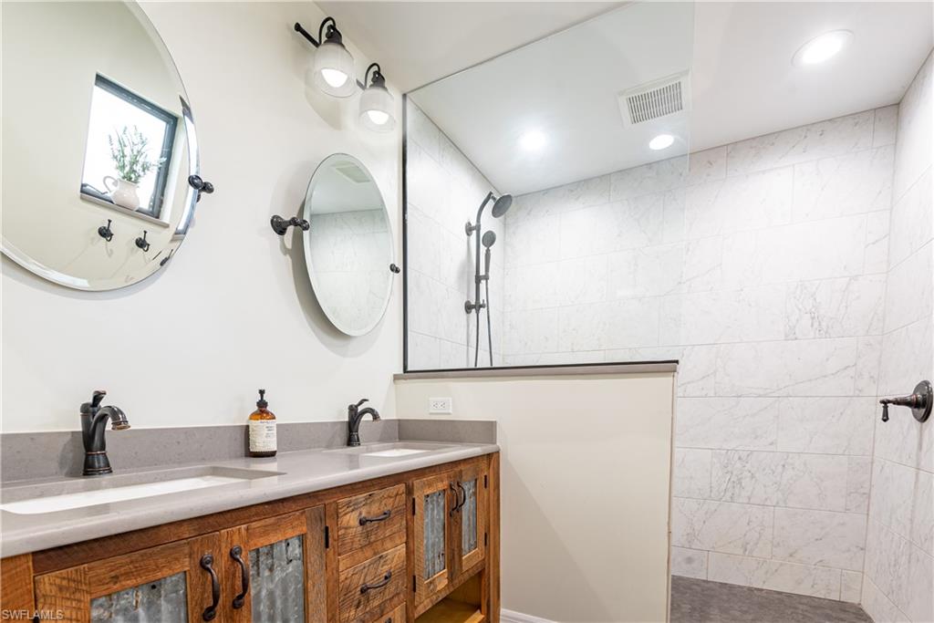 18386 Tulip Road Fort Myers, FL 33967 - Photo 8 of 25 a bathroom with a double vanity sink and a mirror