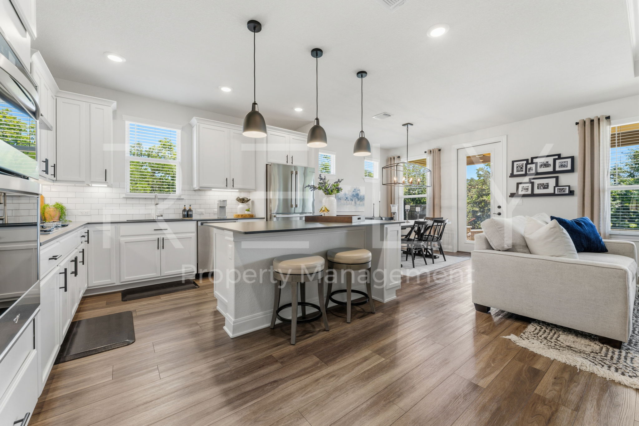 101 Spanish Star Street Georgetown, TX 78633 - Photo 11 of 39 A contemporary open-concept layout features a well-appointed kitchen island flowing into a comfortable living area.