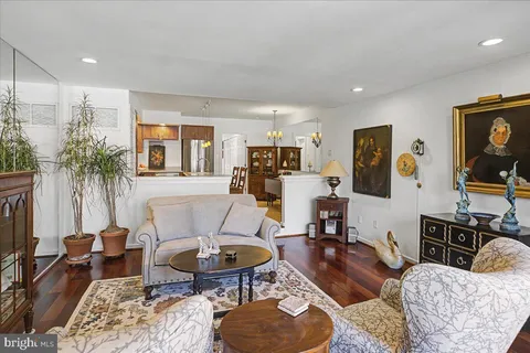 a living room with furniture a rug and a flat screen tv