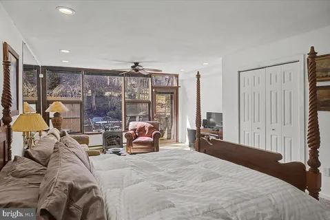 a bed room with a bed and a large window