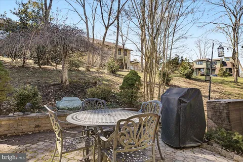 a view of a patio with table and chairs and potted plants
