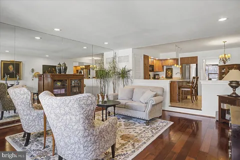 a living room with furniture wooden floor and a table