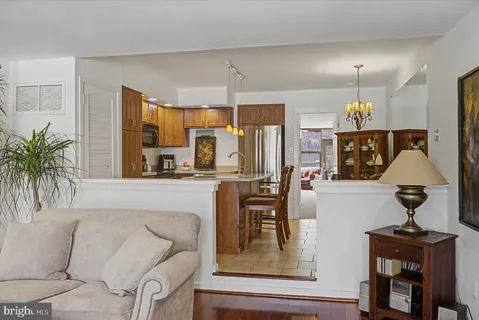 a living room with furniture a chandelier and a fireplace