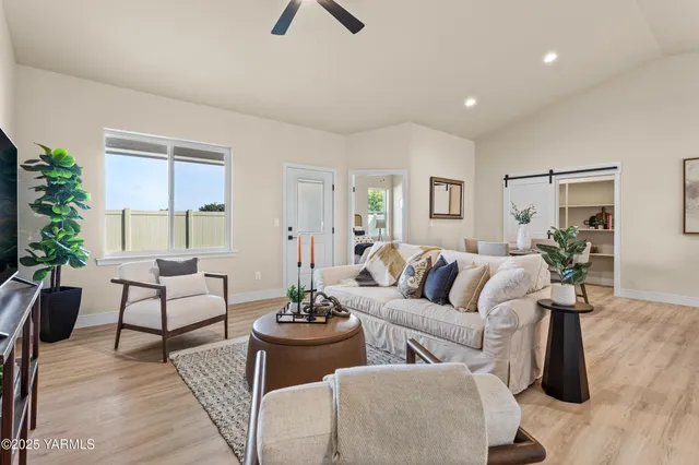a living room with furniture and a large window