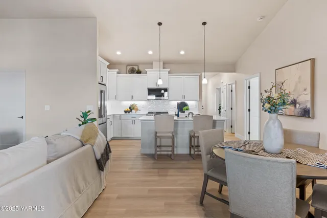 a living room with furniture and kitchen view