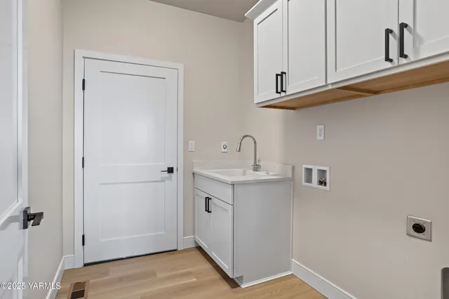 a bathroom with a sink and cabinets