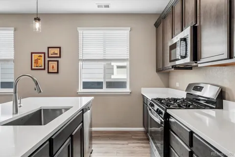 a kitchen with stainless steel appliances granite countertop a sink stove and a granite counter tops