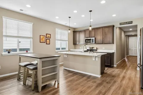 a kitchen with a sink cabinets stainless steel appliances and window