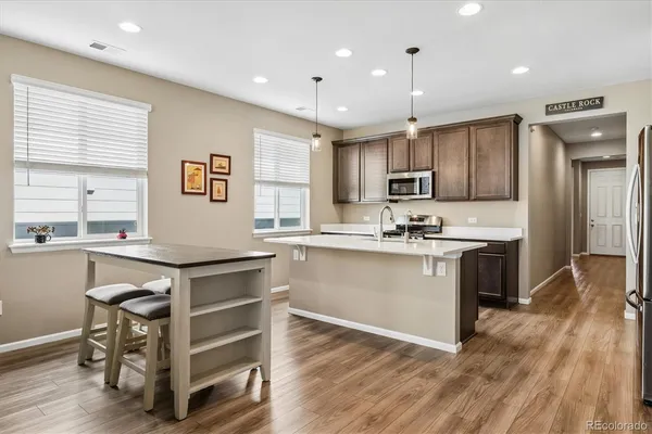 a kitchen with a sink cabinets stainless steel appliances and window