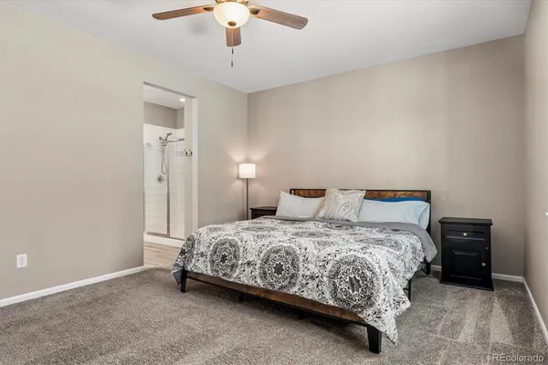 a bedroom with a bed and a lamp