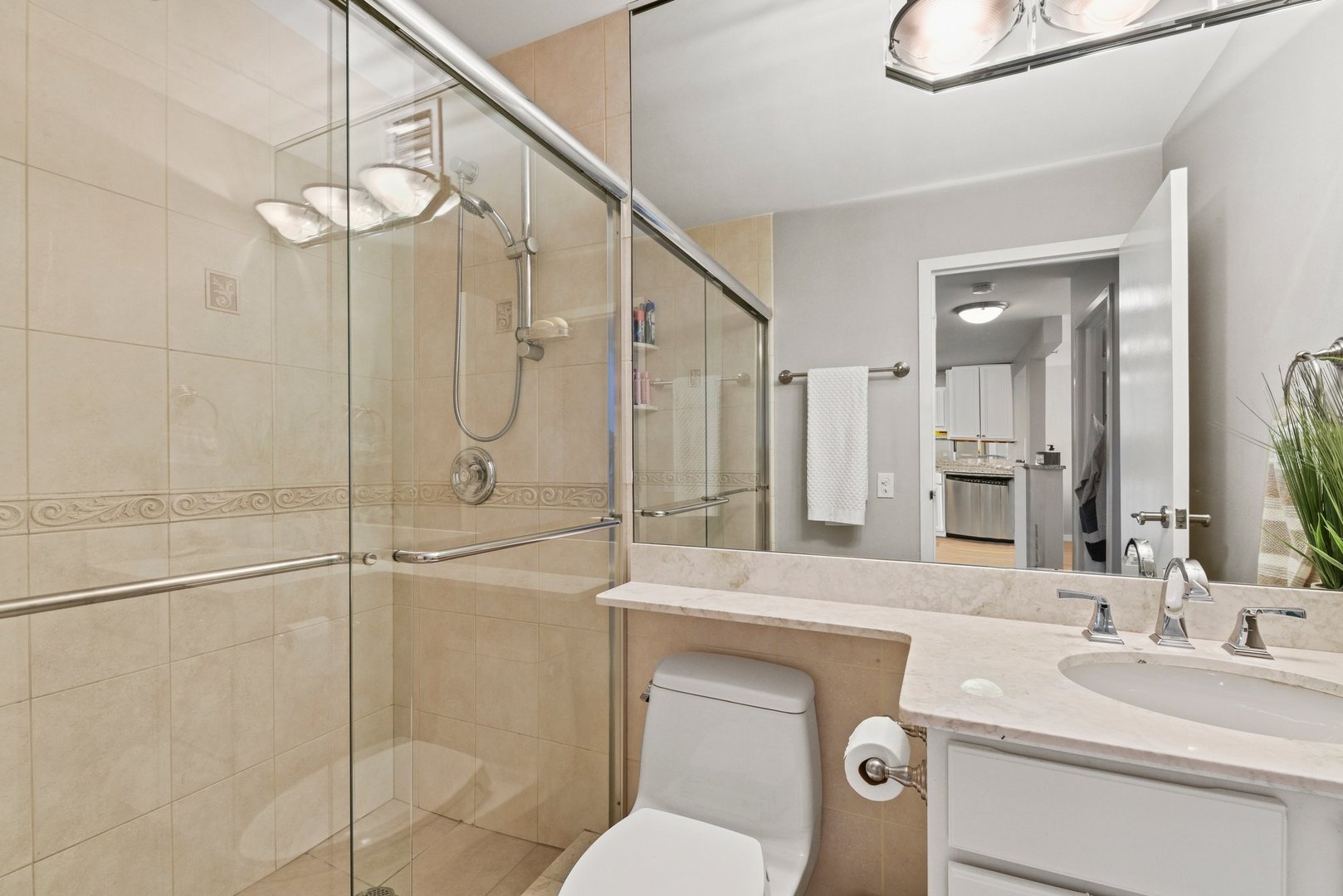 33 West Delaware Place, Unit 23D Chicago, IL 60610 - Photo 10 of 20 a bathroom with a sink a toilet and shower