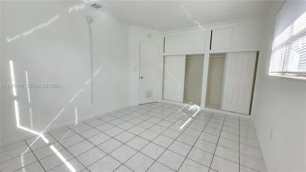 a view of an empty room and window