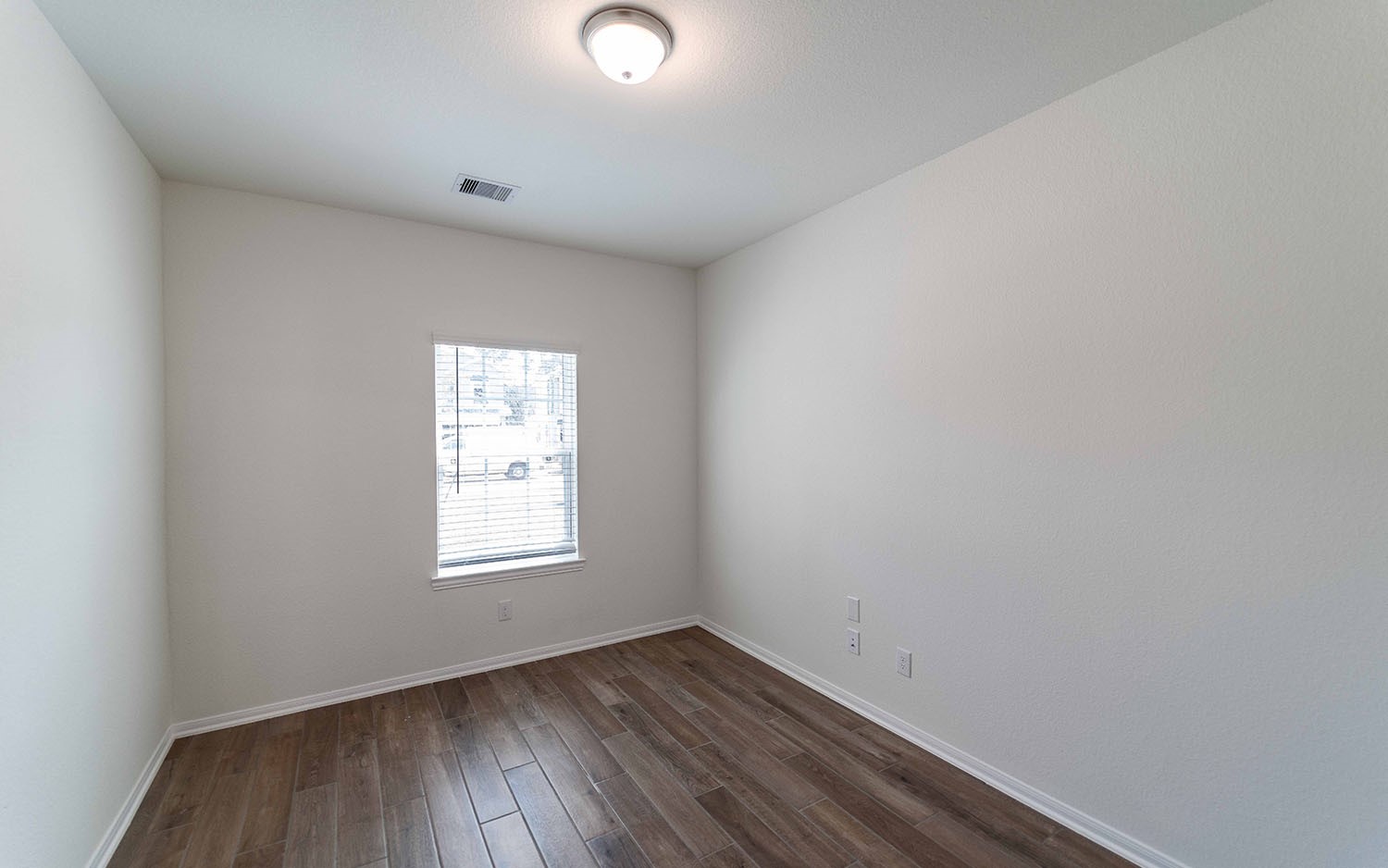 10656 Altitude Way Conroe, TX 77303 - Photo 2 of 30 an empty room with wooden floor and windows