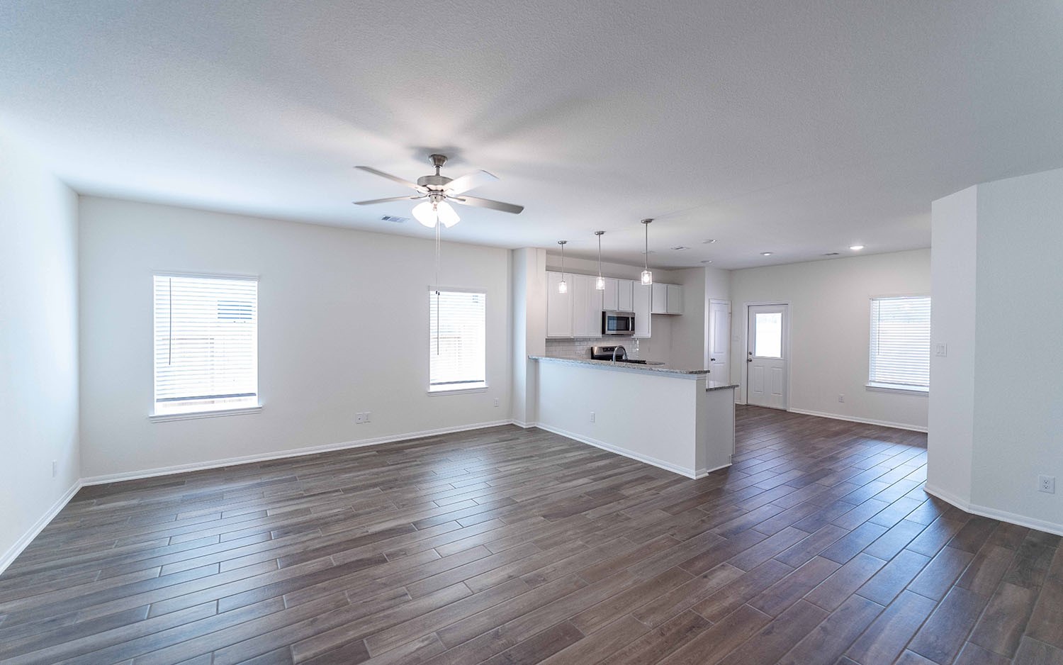 10656 Altitude Way Conroe, TX 77303 - Photo 3 of 30 a view of an empty room with kitchen and window