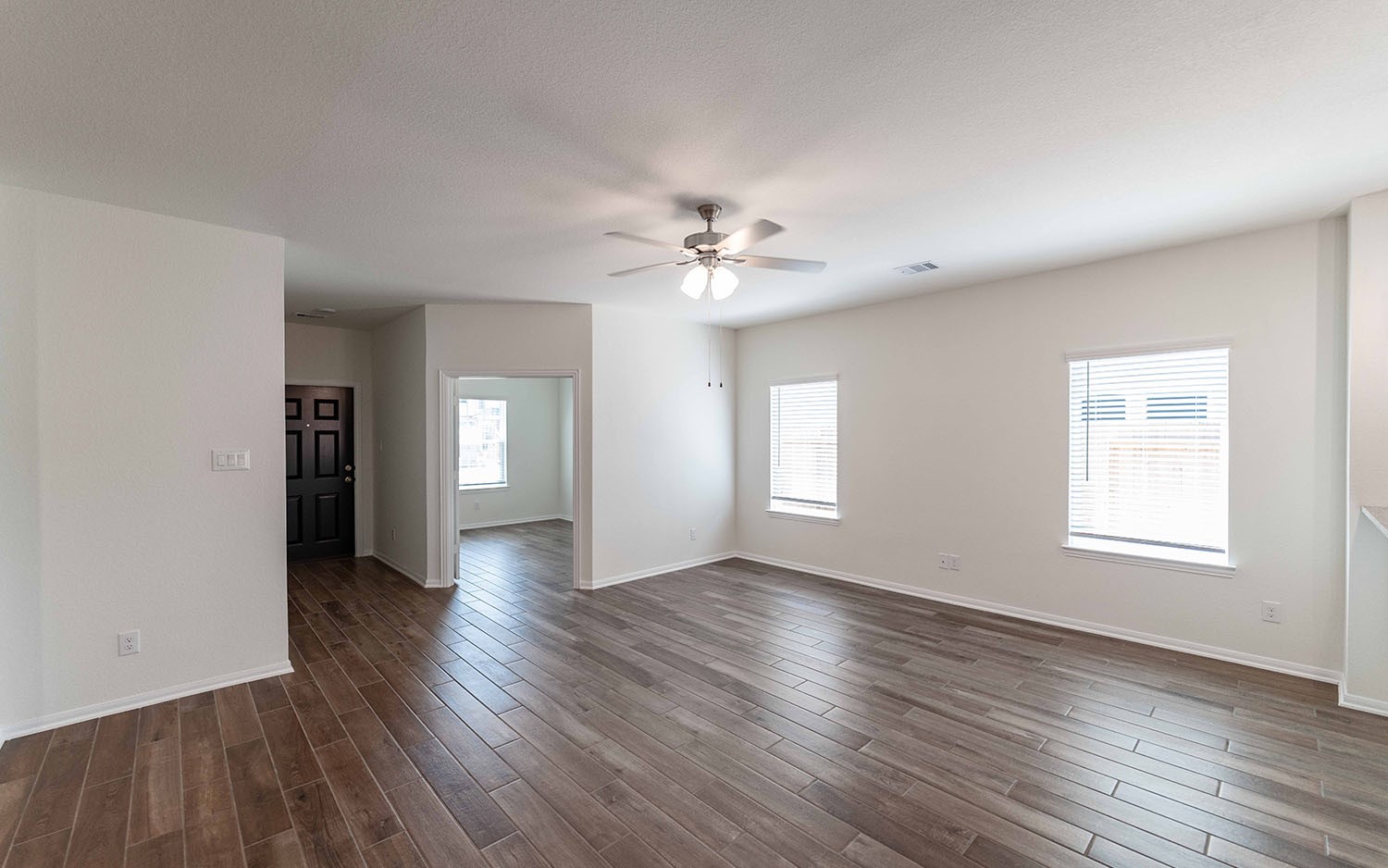 10656 Altitude Way Conroe, TX 77303 - Photo 5 of 30 an empty room with wooden floor and windows