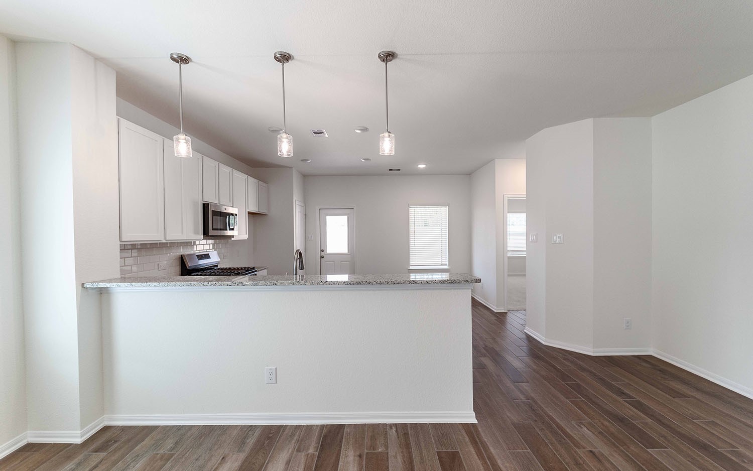 10656 Altitude Way Conroe, TX 77303 - Photo 6 of 30 a large kitchen with cabinets wooden floor and stainless steel appliances