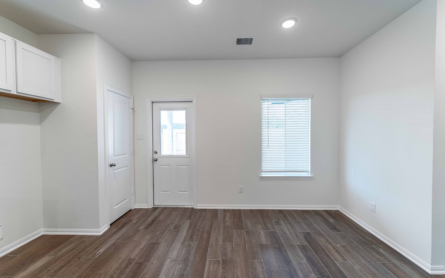 10656 Altitude Way Conroe, TX 77303 - Photo 8 of 30 an empty room with wooden floor and windows