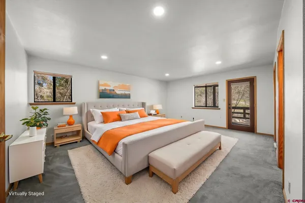 a bed room with a bed couch and a window