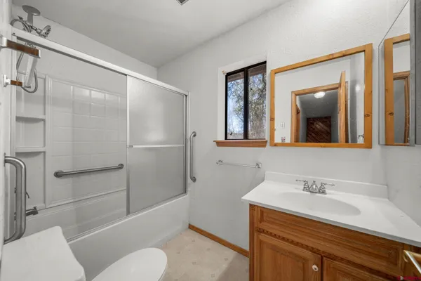 a bathroom with a sink toilet and shower