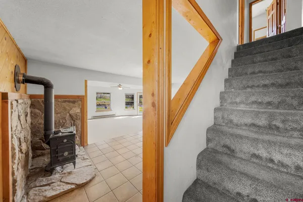 a view of staircase with white walls and a window