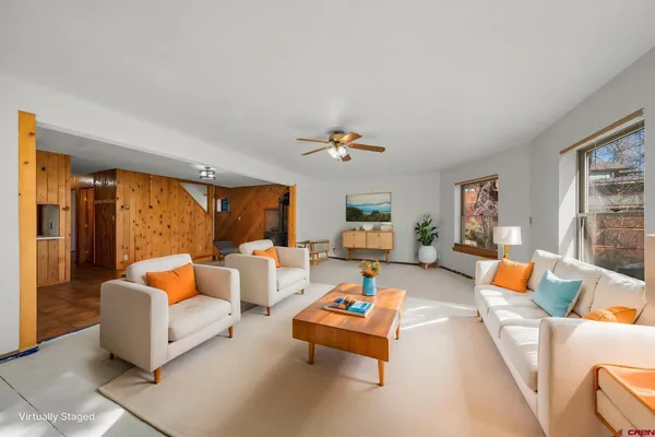 a living room with furniture and a large window