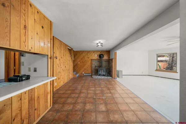 a view of a hallway with wooden floor and a bathroom