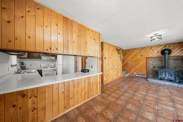 a kitchen with stainless steel appliances a sink cabinets and wooden floor