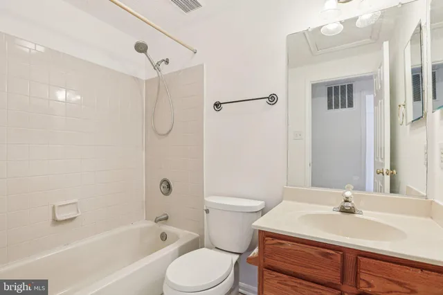 a bathroom with a sink toilet vanity and shower