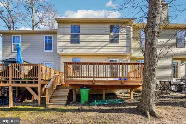 a view of a house with wooden deck
