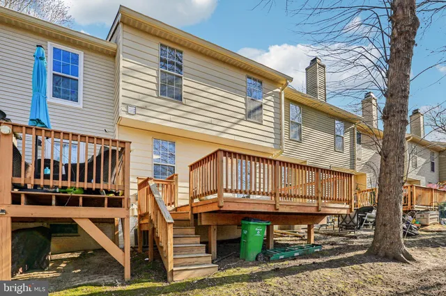 a view of a house with wooden deck