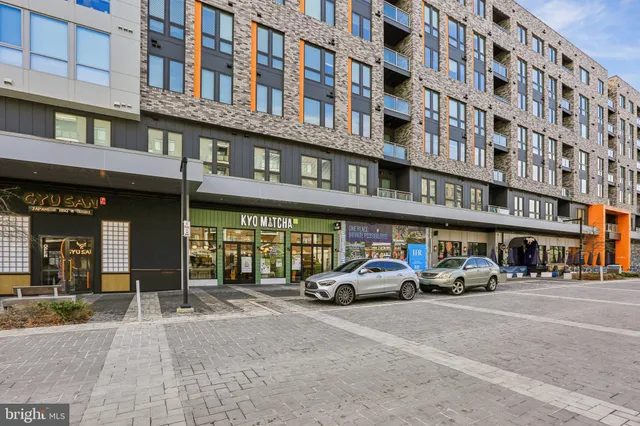 a building with multiple parking space and a car parked