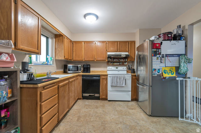 7466 Washington Road Magna, UT 84044 - Photo 11 of 21 Laminate flooring, wood-finish cabinetry, stainless steel refrigerator, white electric range, and black dishwasher
